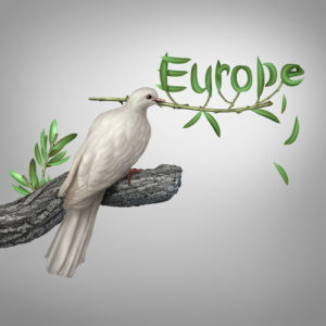 Europe conflict and diplomatic crisis concept as a white dove holding an olive branch with the leaves shaped as text as a hope and risk symbol for peace and finding a peaceful negotiated solution.