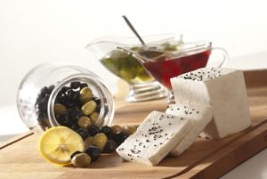 Olives, oils, cheese and butter set out as great party snack ideas.