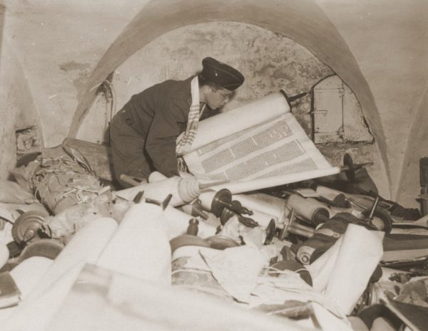 Chaplain Samuel Blinder examining Torah scrolls.
