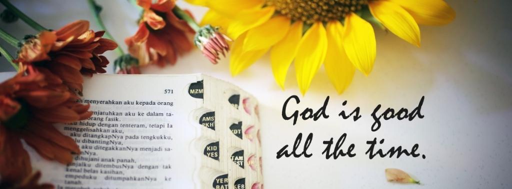 Open Bible next to sunflower with text reading God is good all the time.
